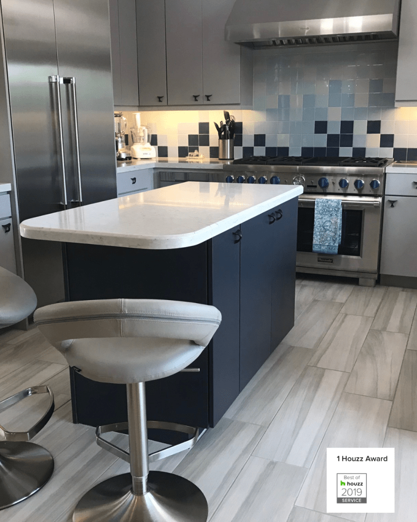 photo of kitchen remodel with dining booth, and grey kitchen cabinets and navy blue center island with cream quartz countertop and stainless steel appliances 1 Houzz Award