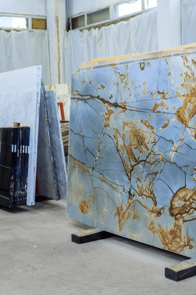 10 marble slabs standing up on stands for full view in a slab yard 